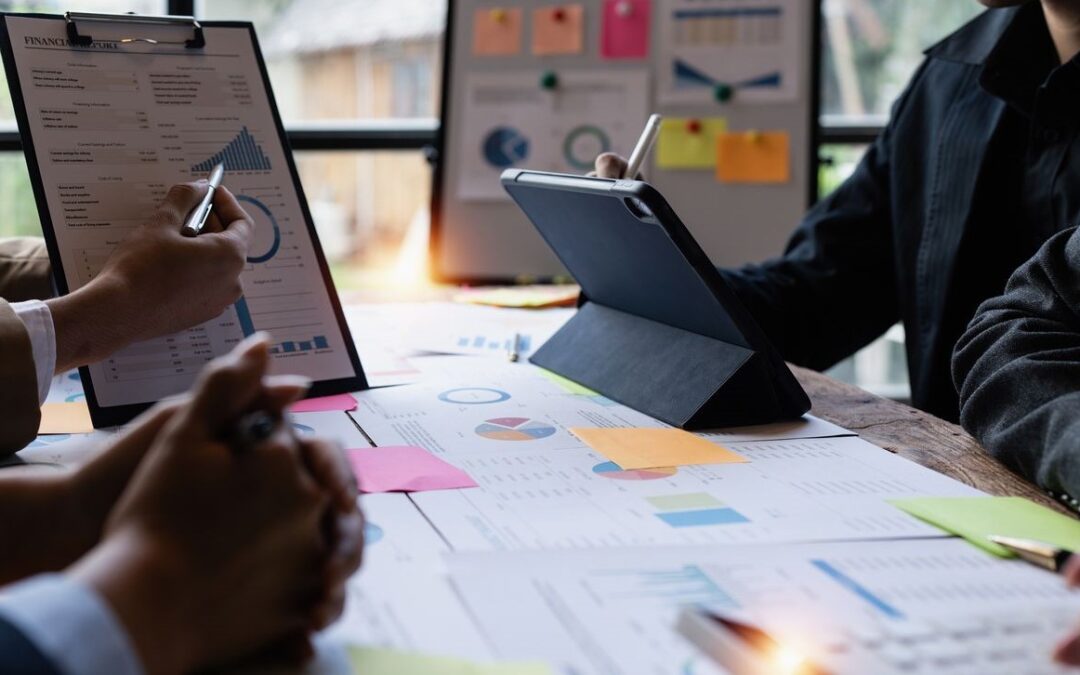 people in a meeting with paper analytical data